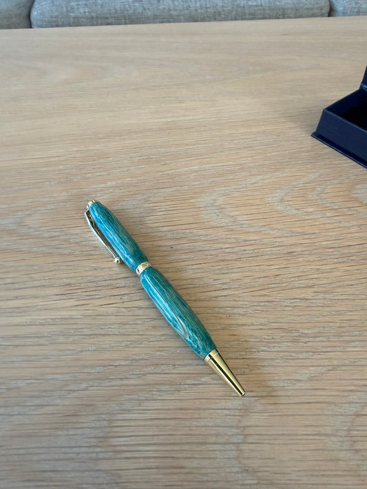 Hand-turned pen in colored oak with 24k gold plating